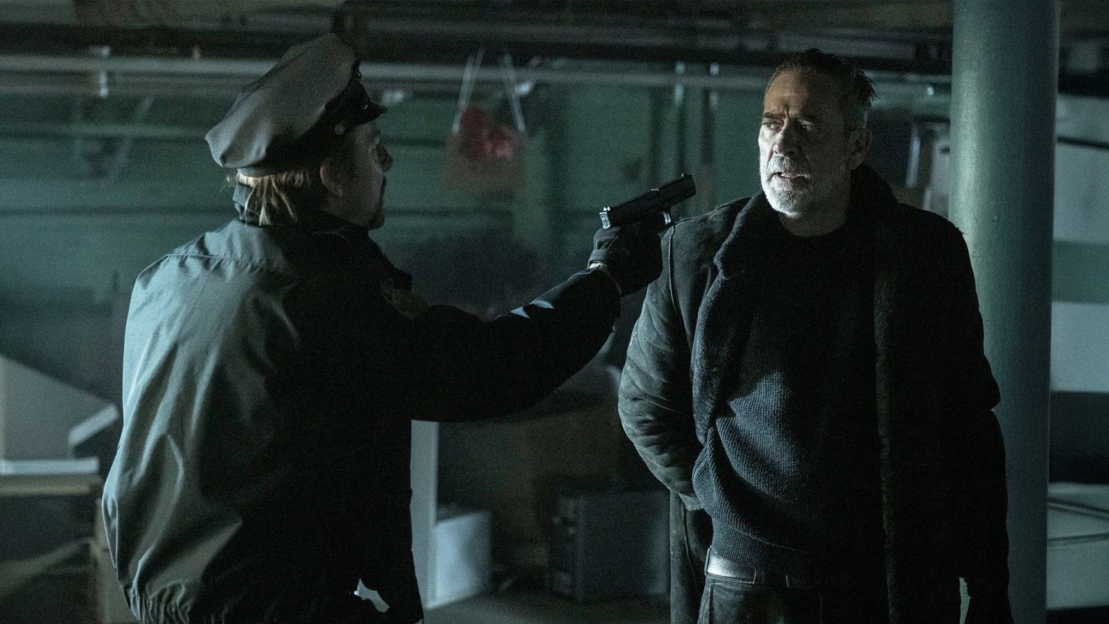Mason Dillard, in his old NYPD cap, holds a pistol on Negan in the Dead City season 3 finale