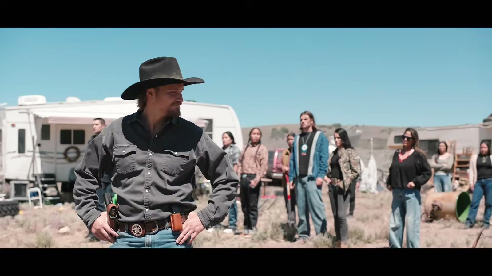 Luke Grimes as Kayce Dutton facing a crowd at a camp in the Marshals season 2 trailer